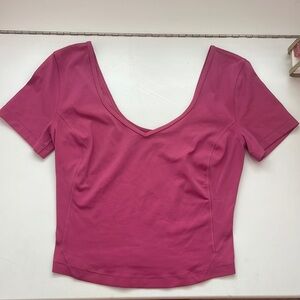 This lululemon align t-shirt is in a size 2 and is a dark pink magenta color.